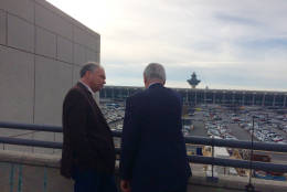 Virginia Sen. Tim Kaine discusses the Silver Line extension currently under construction with Charles Stark, executive director of the project, at Dulles International Airport on Tuesday, Dec. 13, 2016. The extension includes a station at the airport. (WTOP/Nick Iannelli)