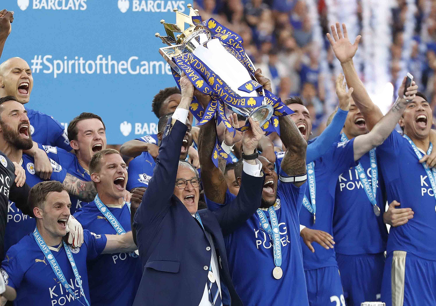 Leicesters team manager Claudio Ranieri and Leicesters Wes Morgan lift the trophy as Leicester City celebrate becoming the English Premier League soccer champions at King Power stadium in Leicester, England, Saturday, May 7, 2016.(AP Photo/Matt Dunham)