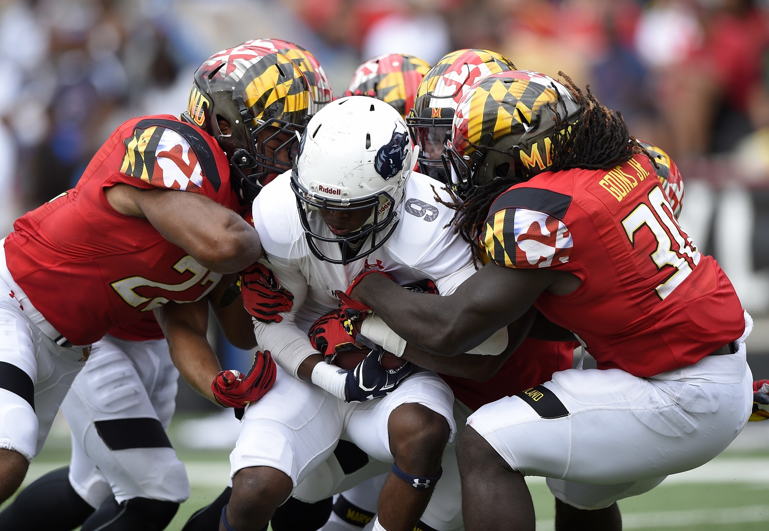FILE - In this Sept. 3, 2016, file photo, Howard kick returner Jalen Avery (9) is tackled by Maryland's Kenneth Goins Jr. (30), Isaiah Davis, left, and others on a punt return in the second half of an NCAA football game in College Park, Md. After spending last season as Michigan's defense coordinator, Maryland first-year coach DJ Durkin must improve his own defense if the Terrapins are to have a chance to upset the second-ranked Wolverines on Saturday. (AP Photo/Nick Wass, File)
