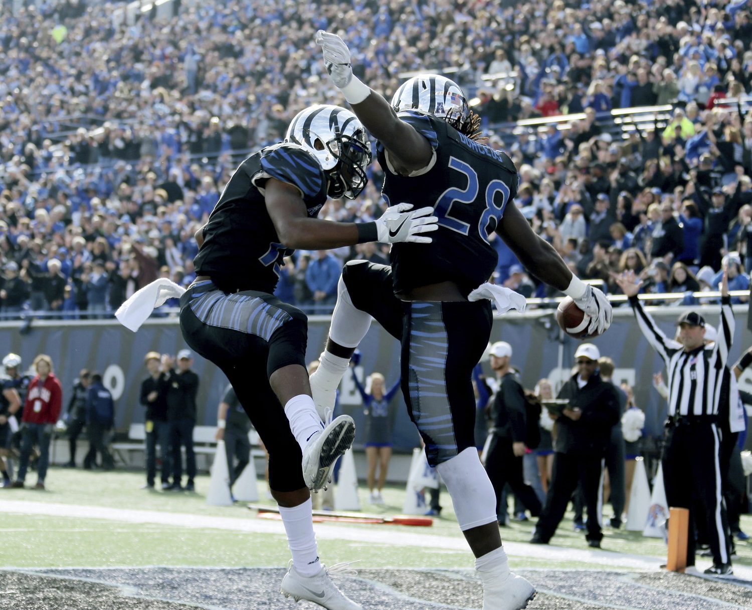 Memphis linebacker DeMarco Montgomery, left, and tail back Doroland Dorceus (28) celebrate a touchdown in the first half of an NCAA college football game Friday, Nov. 25, 2016, in Memphis, Tenn. (AP Photo/Nikki Boertman)