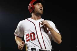 Washington Nationals' Daniel Murphy celebrates as he crosses home while scoring on a triple hit by teammate Bryce Harper during a baseball game against the Colorado Rockies at Nationals Park, Friday, Aug. 26, 2016 in Washington. (AP Photo/Pablo Martinez Monsivais)