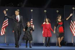 FILE - In this Nov. 4, 2008, file photo, then-President-elect Barack Obama, left, his wife Michelle Obama, right, and daughters, Malia, and Sasha, second from left, wave to the crowd at the election night rally in Chicago. (AP Photo/Jae C. Hong)