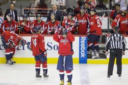 Washington Capitals left wing Alex Ovechkin (8), of Russia, acknowledges the fans in celebration as he comes back out of the box to a standing ovation after  Ovechkin scored his 500th career NHL goal during the second period of a hockey game against the Ottawa Senators in Washington, D.C., Sunday, Jan. 10, 2016. (AP Photo/Jacquelyn Martin)