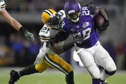 Minnesota Vikings running back Adrian Peterson (28) tries to break a tackle by Green Bay Packers free safety Ha Ha Clinton-Dix, left, during the first half of an NFL football game Sunday, Sept. 18, 2016, in Minneapolis. (AP Photo/Andy Clayton-King)