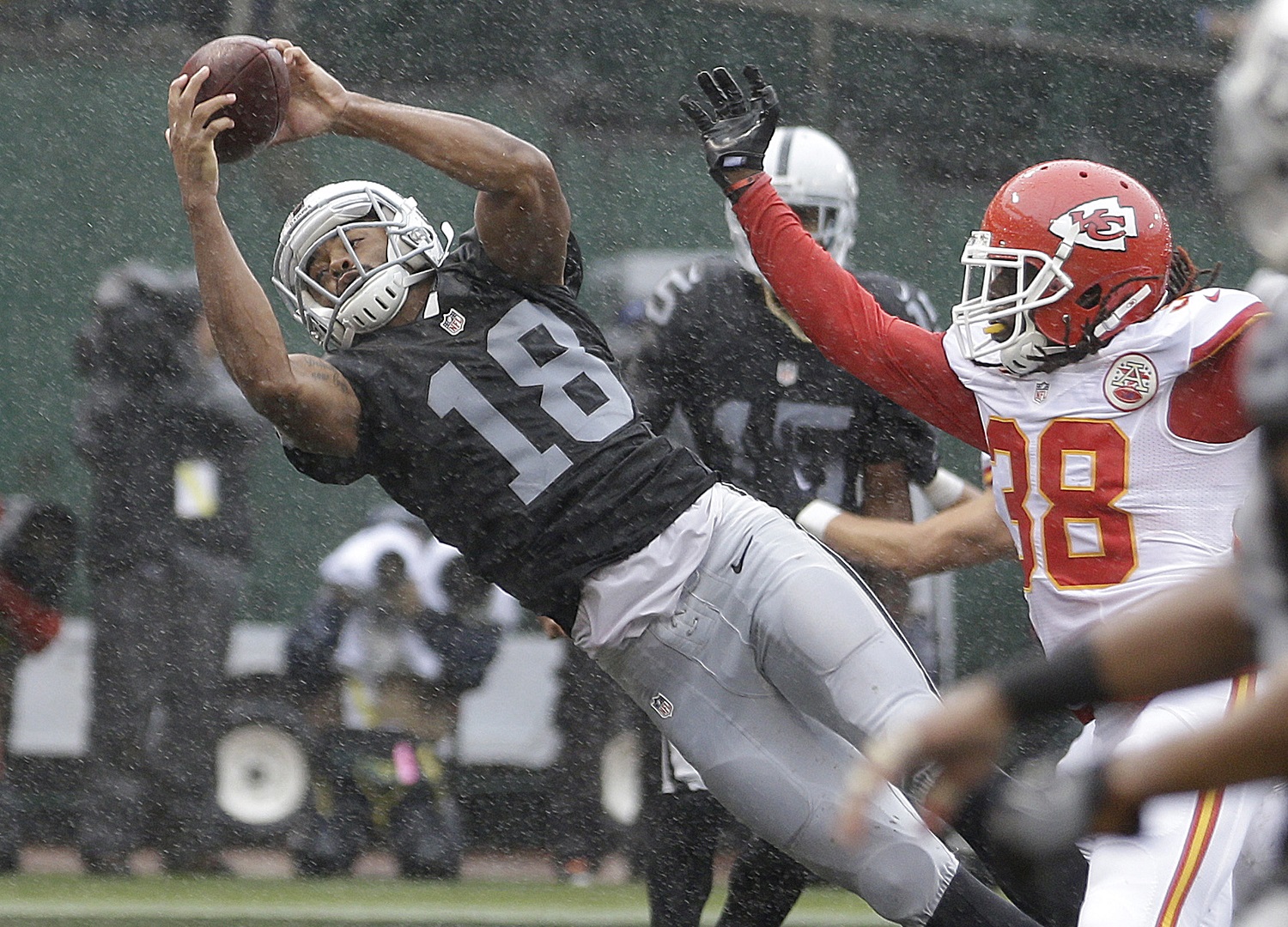 Oakland Raiders wide receiver Andre Holmes (18) catches a touchdown pass next to Kansas City Chiefs defensive back Ron Parker (38) during the first half of an NFL football game in Oakland, Calif., Sunday, Oct. 16, 2016. (AP Photo/Ben Margot)