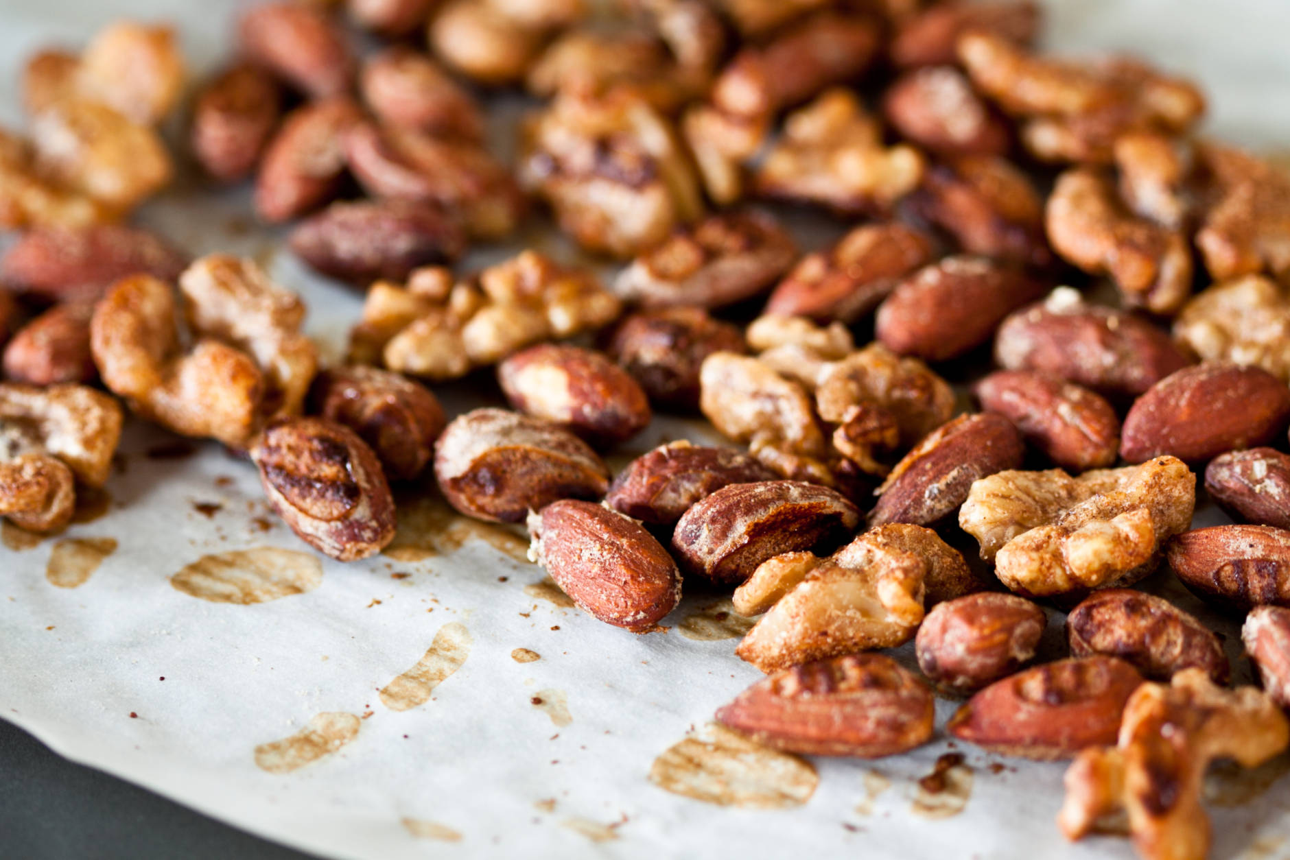 Spiced almonds and walnuts on a baking sheet