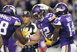 Minnesota Vikings tight end Kyle Rudolph, center, celebrates with teammates T.J. Clemmings, left, and Stefon Diggs, right, after catching a 7-yard touchdown pass during the first half of an NFL football game against the New York Giants on Monday, Oct. 3, 2016, in Minneapolis. (AP Photo/Andy Clayton-King)
