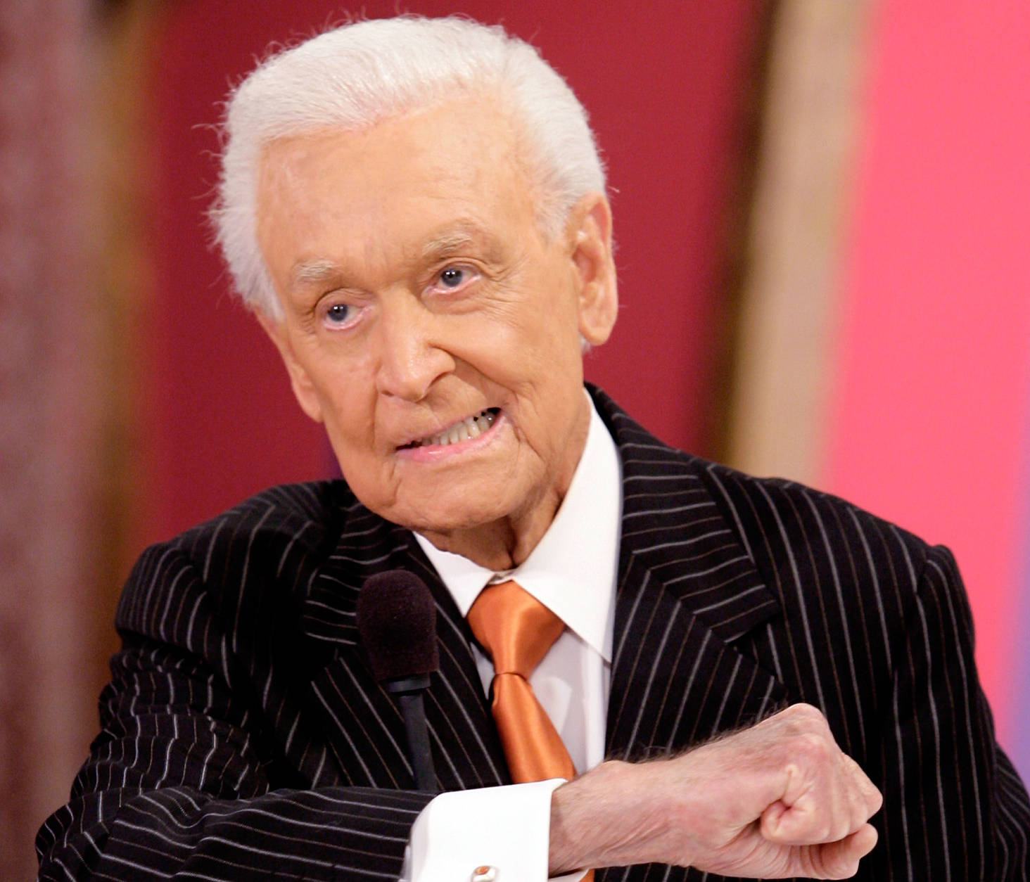 ** FILE **Television game show host Bob Barker gestures during live taping of "The Price Is Right" at the CBS Studios in Los Angeles, in this Oct.2006 file photo. A woman has sued Bob Barker and the producers of "The Price is Right," alleging she was forced to quit working on the game show. (AP Photo/Damian Dovarganes, file)