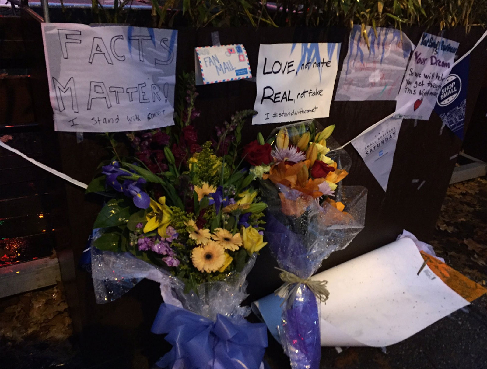 Signs of support and flowers were still outside Comet Ping Pong as it reopened Tuesday. 
(WTOP/Michelle Basch)