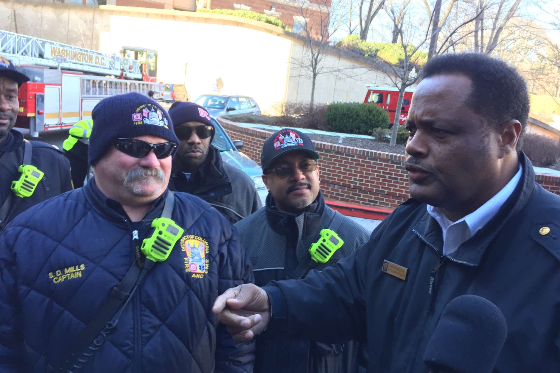 Battalion Chief David Mclain tells firefighters about another child to visit who is too ill to come outside. (WTOP/Krist King)