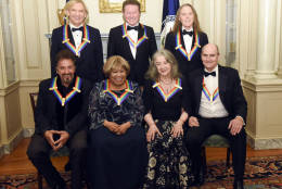 The 2016 Kennedy Center Honorees, front row, from left, Al Pacino, Mavis Staples, Martha Argerich and James Taylor, back row, from left, Joe Walsh, Don Henley and Timothy Schmit are photographed at the State Department for the Kennedy Center Honors gala dinner, Saturday, Dec. 3, 2016, in Washington. (AP Photo/Kevin Wolf)