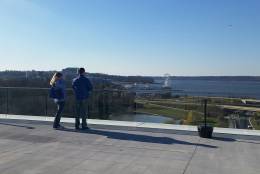 Two guests of the MGM National Harbor view the landscape from outdoors. (WTOP/Kathy Stewart)