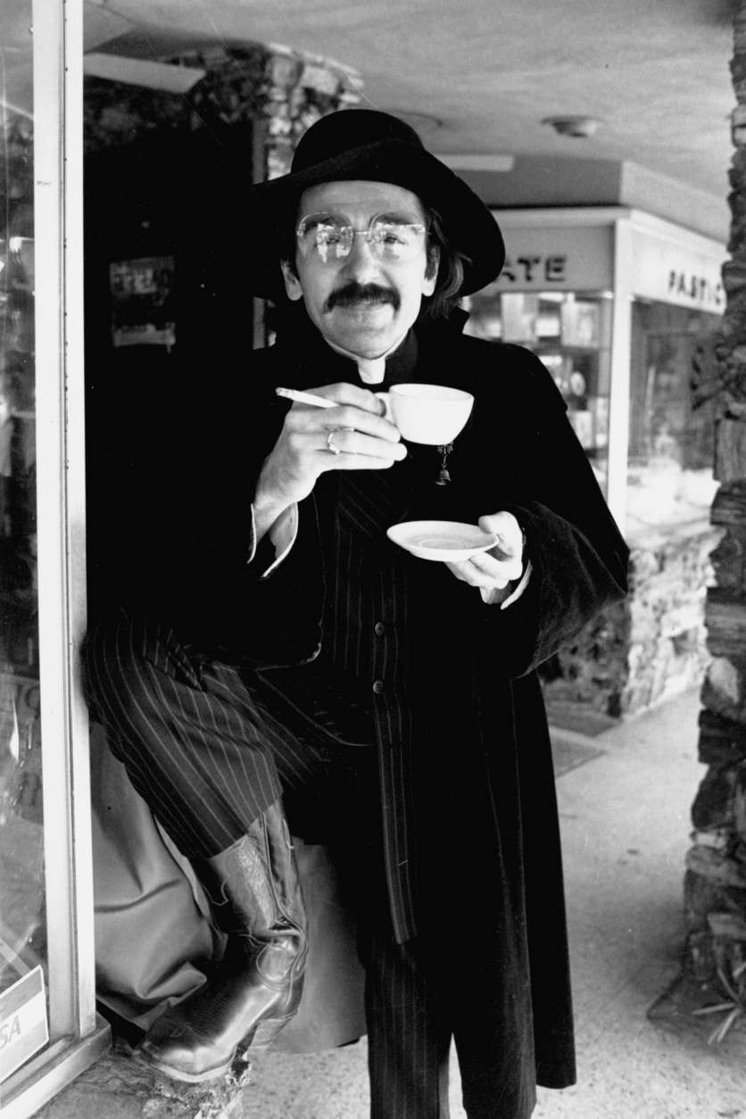 Actor Don Novello poses as Father Guido Sarducci, a character he portrays on "Saturday Night Live," as he smokes a cigarette and drinks a cup of coffee in Los Angeles, Calif., in 1980.  His character is a self-styled Vatican columnist on the weekly television variety show.  (AP Photo/Wally Fong)