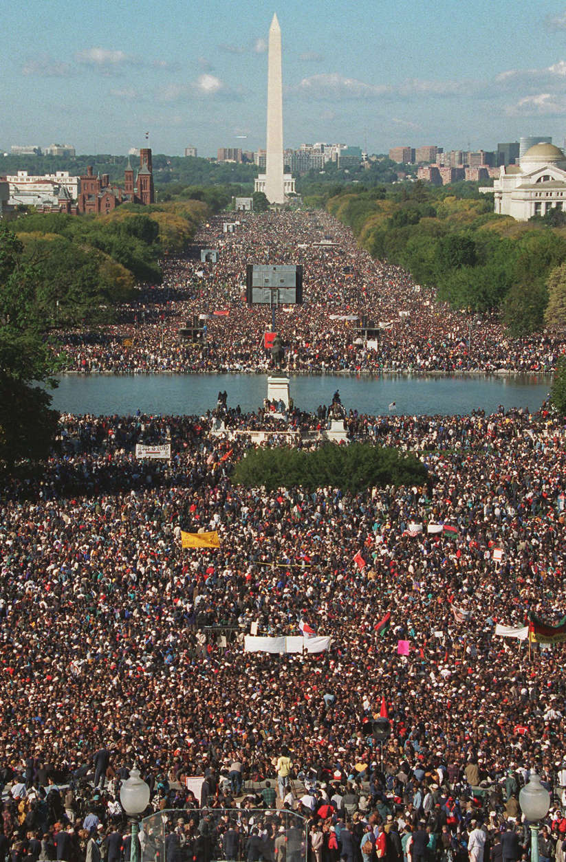 With the Washington Monument in the background, participants in the Million Man March gather on Capitol Hill and the Mall in Washington Monday Oct. 16, 1995. Tens of thousands of black men from across America gathered at the base of the Capitol, and the Mall, in a rally of unity, self-affirmation and protest. (AP Photo/Mark Wilson)
