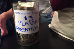 A jar taking donations for Planned Parenthood was at the checkout of the women's march "pop-up" store on 18th Street in Northwest D.C. (WTOP/Megan Cloherty)