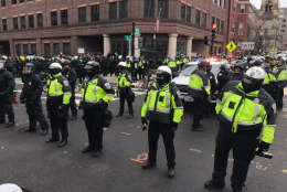 Arrests being made at 12th and L.  Protesters searched one by one, and brought to police van. (WTOP/Neal Augenstein)