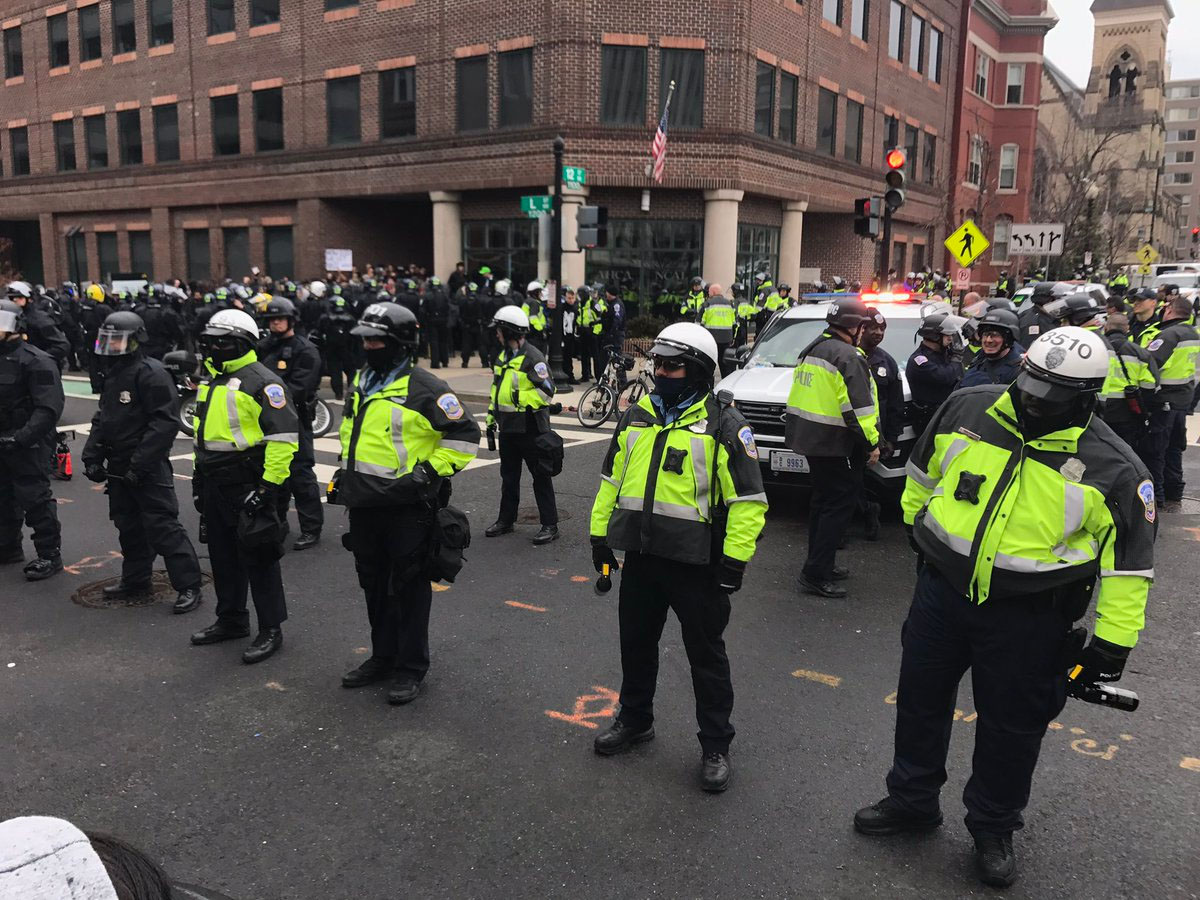 Arrests being made at 12th and L.  Protesters searched one by one, and brought to police van. (WTOP/Neal Augenstein)