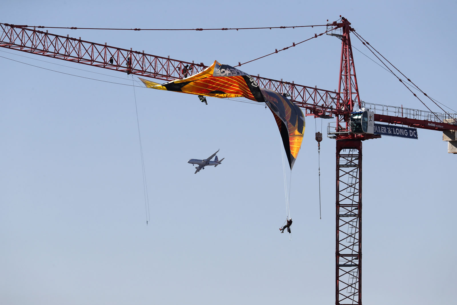 An airplane flies by the construction site of the former Washington Post building in Washington, Wednesday, Jan. 25, 2017, where Greenpeace protesters unfurled a banner that reads "Resist." (AP Photo/Carolyn Kaster)