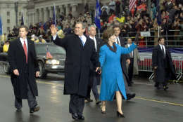 ** FILE ** With Secret Service agents accompanying them, President Bush and first lady Laura Bush wave as they walk down Pennsylvania Avenue during the Inaugural Parade in Washington  in this Jan. 20, 2001 file photo.   Security for the 2005 inauguration is expected to be the tightest in inaugural history.  (AP Photo/Doug Mills, File)