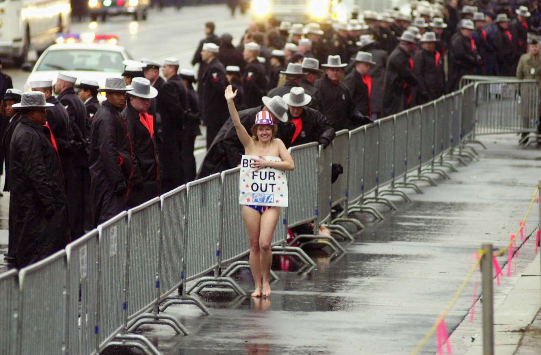 A topless protester runs past a police barricade along Pennsylvania Avenue during President Bush's inaugural parade Saturday, Jan. 20, 2001, in Washington. (AP Photo/Robert F. Bukaty)