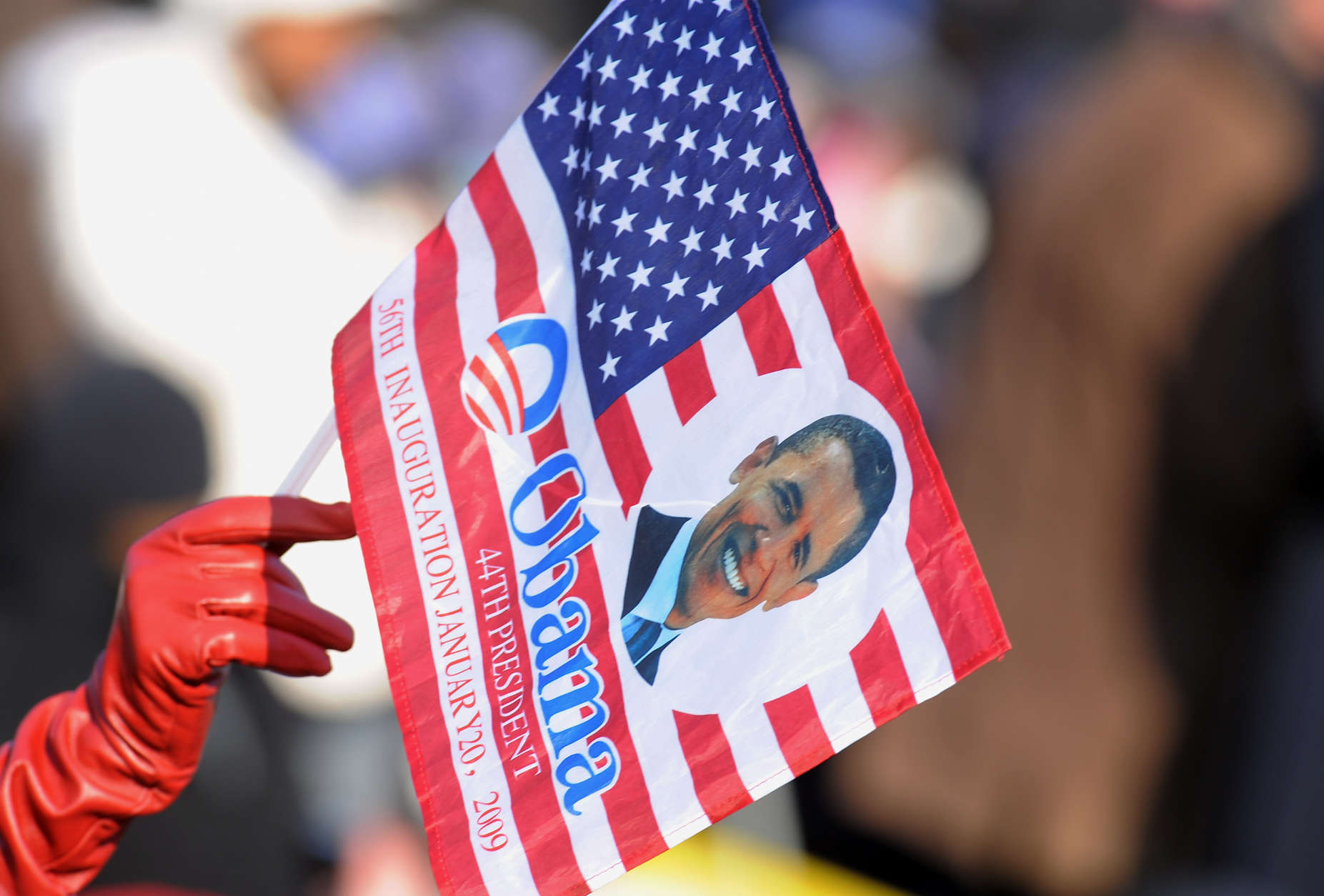 A spectator in the crowd waves a souvenir Barack Obama flag prior to the Presidential Inauguration in Washington, Tuesday, Jan. 20, 2009.   (AP Photo/Evan Agostini)