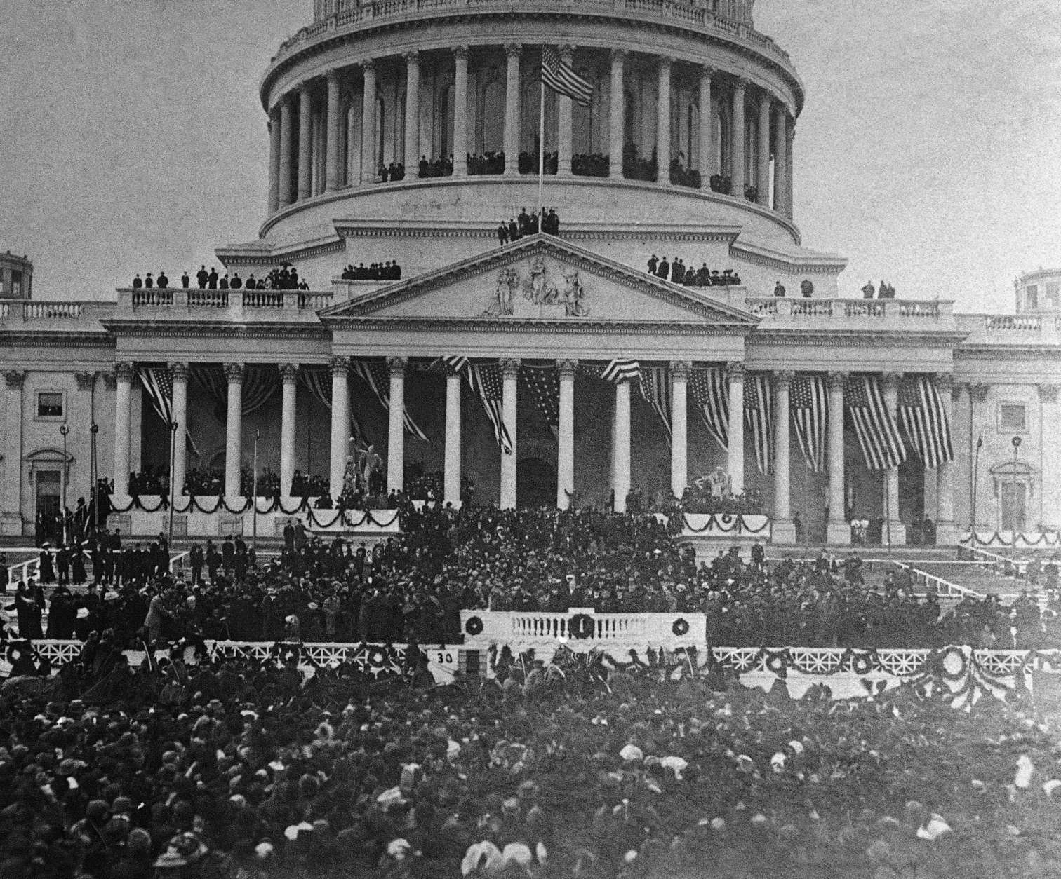 President William Howard Taft  sits in a horse draw carriage beside his wife Helen  in front of the white podium area of photo after Inaugural  ceremonies at the Capitol, in center of photo.  The president and his procession are preparing to leave the Capitol area.   The inauguration took place in the Senate chamber because of a blizzard on March 4, 1909.   For the first time in the country's history, the president's wife  accompanied her husband on the return ride in the procession from the Capitol to the White House following his Inauguration.    (AP Photo/Library of Congress)