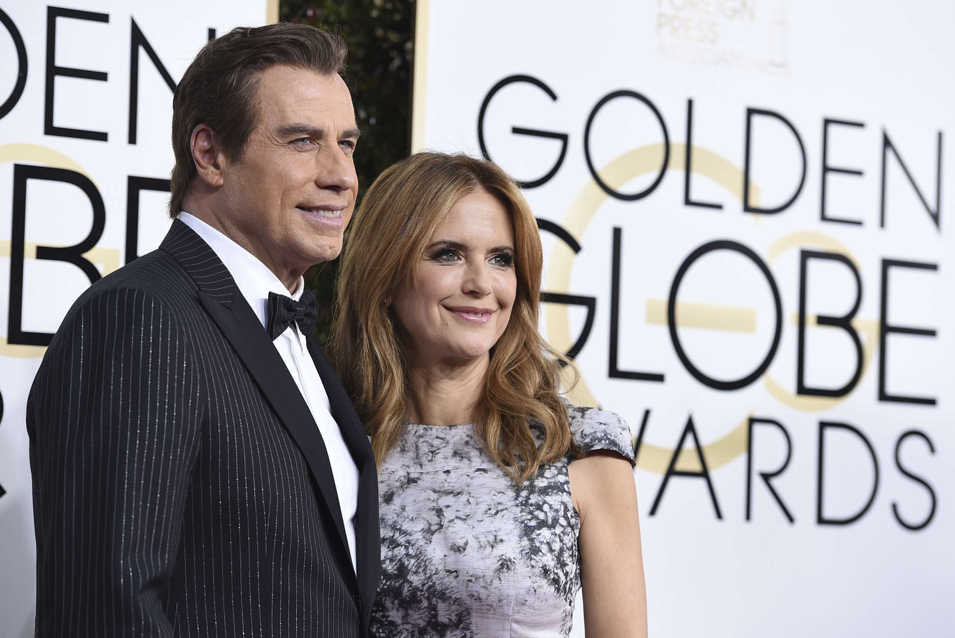 John Travolta, left, and Kelly Preston arrive at the 74th annual Golden Globe Awards at the Beverly Hilton Hotel on Sunday, Jan. 8, 2017, in Beverly Hills, Calif. (Photo by Jordan Strauss/Invision/AP)