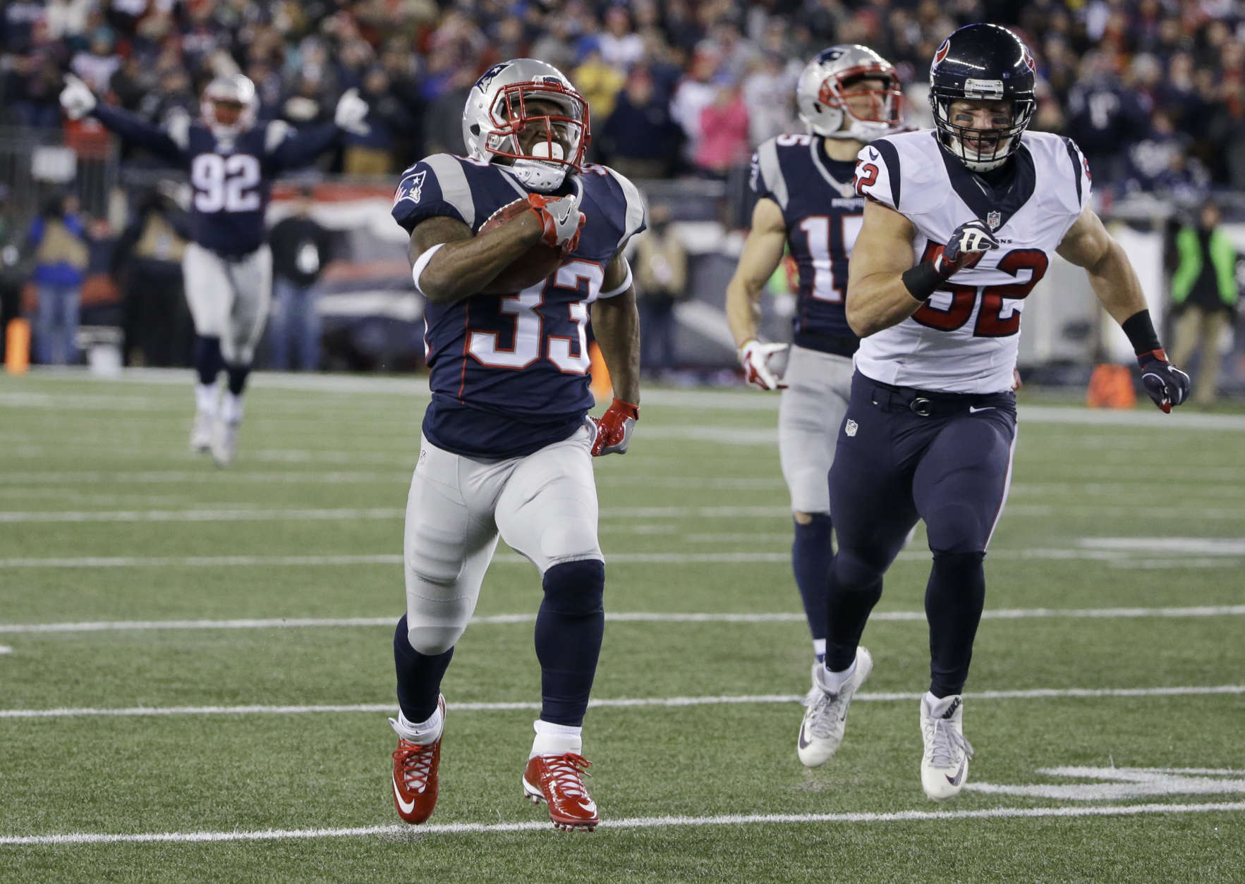 New England Patriots running back Dion Lewis (33) runs ahead of Houston Texans linebacker Brian Peters (52) for a touchdown during the first half of an NFL divisional playoff football game, Saturday, Jan. 14, 2017, in Foxborough, Mass. (AP Photo/Elise Amendola)