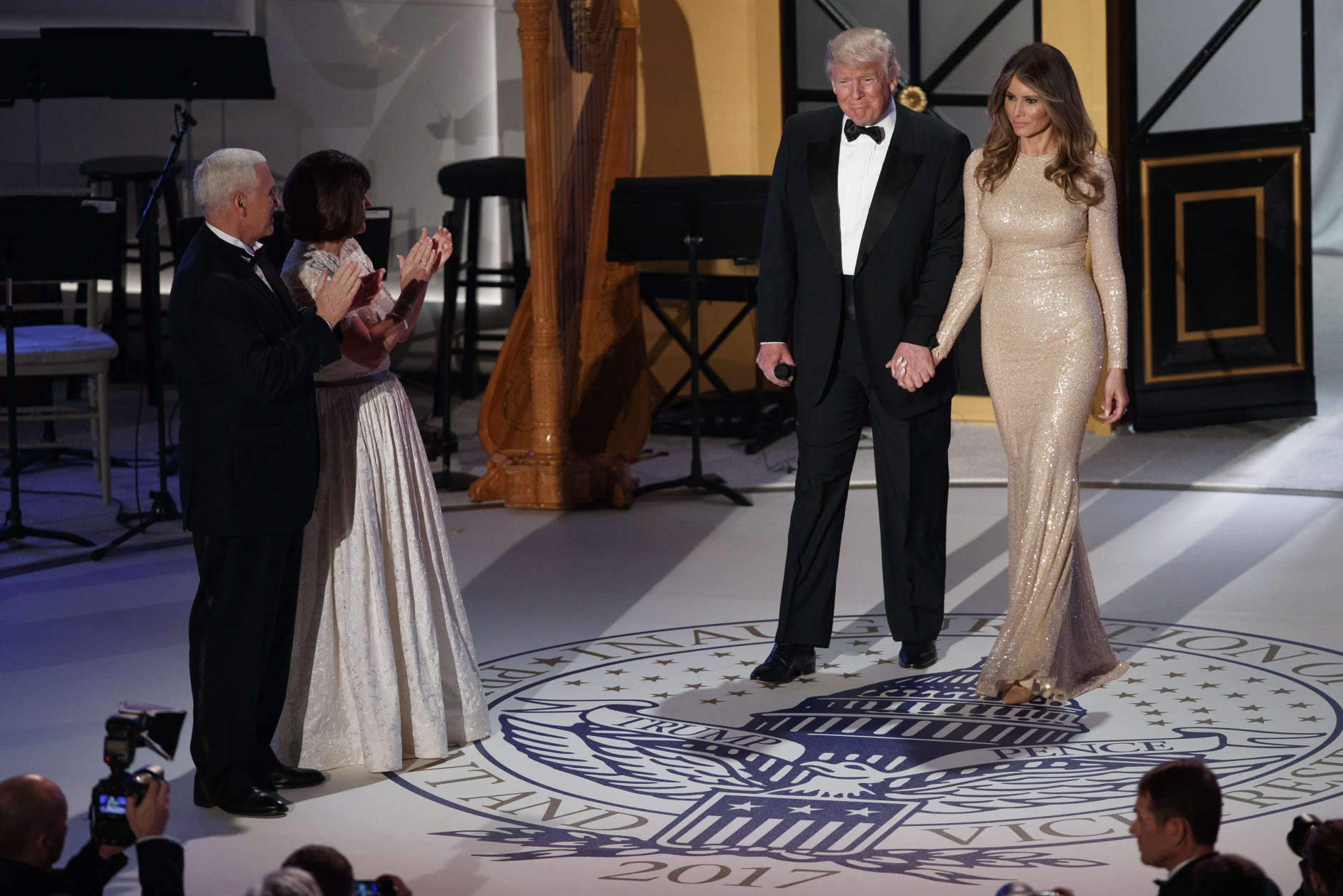 Vice President-elect Mike Pence, left, and his wife Karen, second from left, applaud as President-elect Donald Trump and his wife Melania arrive for a VIP reception and dinner with donors, Thursday, Jan. 19, 2017, in Washington. (AP Photo/Evan Vucci)