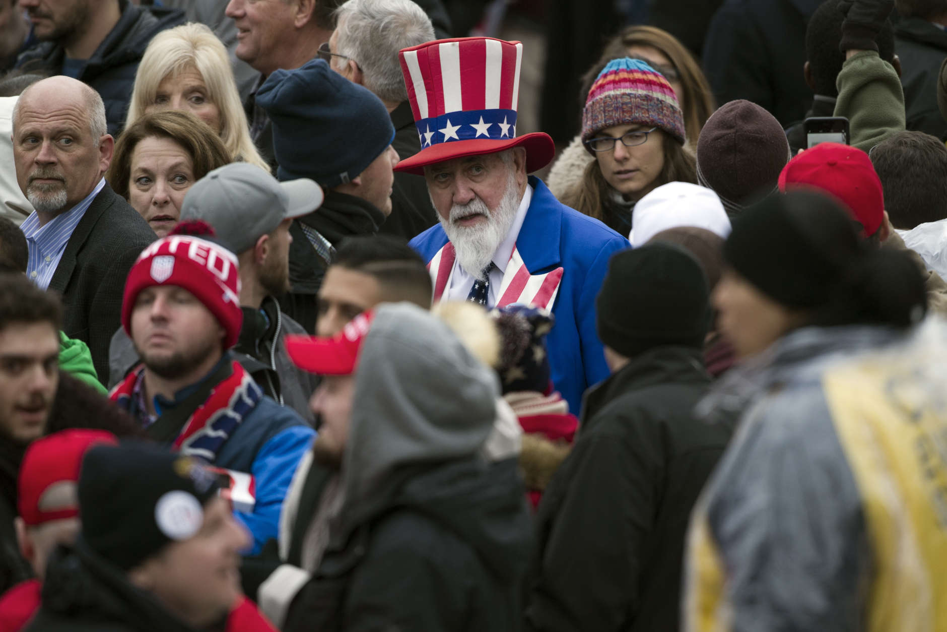 A man dressed as Uncle Sam walks through the crowd as they wait on Pennsylvania Avenue in Washington, Friday, Jan. 20,2017,  for the start of the President Donald Trump's Inaugural Parade. (AP Photo/Cliff Owen)