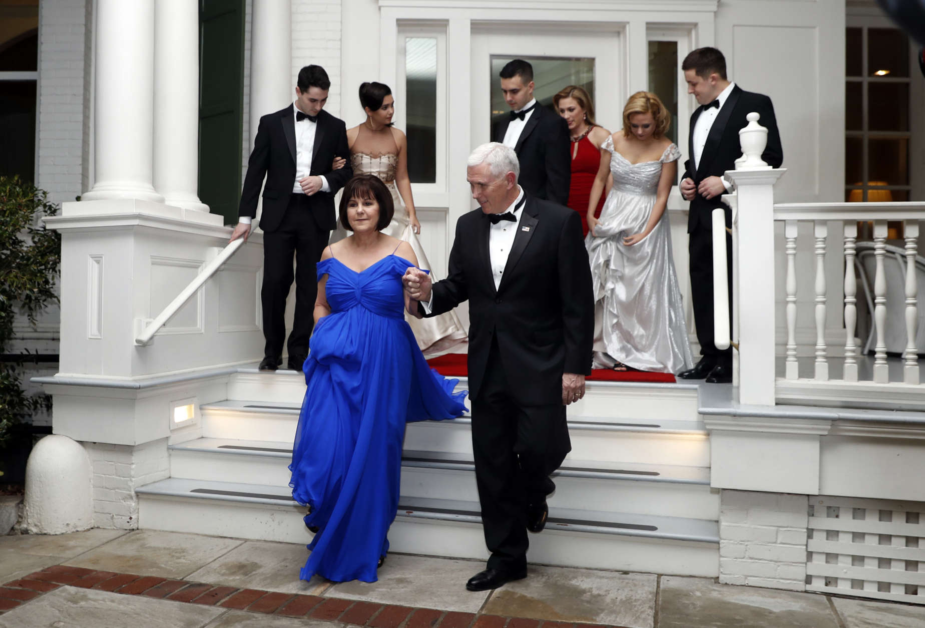Vice President Mike Pence right, assists his wife Karen Pence as they depart the Naval Observatory for several inaugural balls, Friday, Jan. 20, 2017 in Washington. (AP Photo/Alex Brandon)