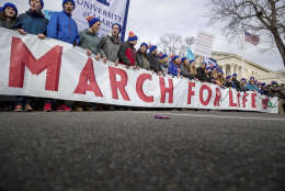 Anti-abortion activists march past the Supreme Court in Washington, Friday, Jan. 27, 2017, during the annual March for Life. Thousands of anti-abortion demonstrators gathered in Washington for an annual march to protest the Supreme Court's landmark 1973 decision that declared a constitutional right to abortion. (AP Photo/Andrew Harnik)