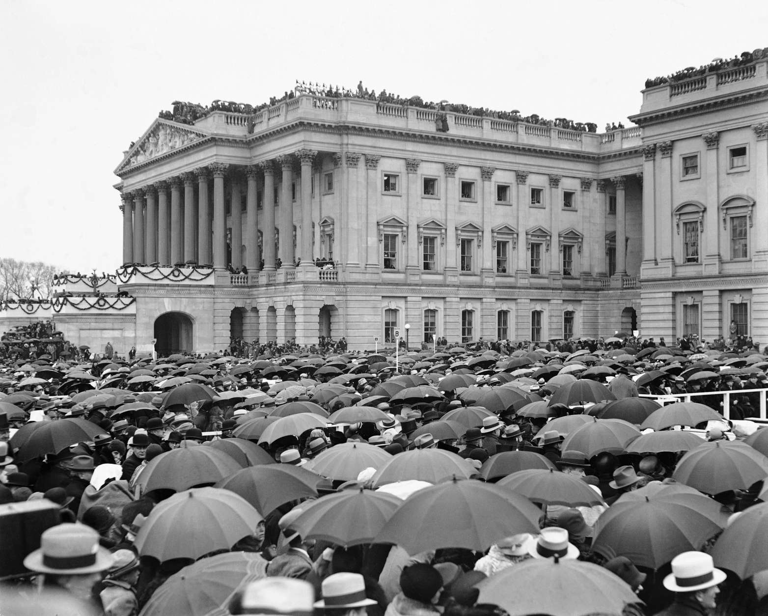 Crowds stand in the rain as they witness the inauguration of Herbert Hoover in Washington, D.C., March 4, 1929.  (AP Photo)