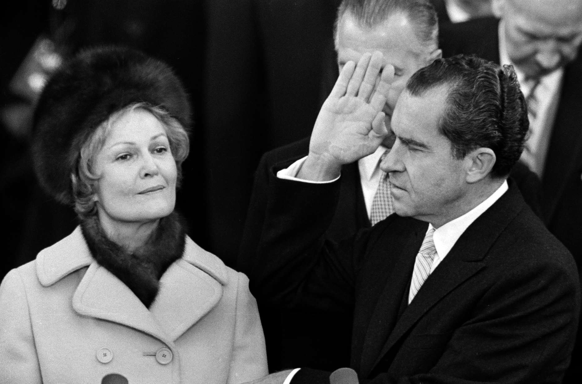 Richard Nixon holds his left hand on two family bibles and raises his right as he takes the oath as 37th President of the United States on the Capitol steps in Washington, D.C., Jan. 20, 1969. Behind his right hand is Vice President Spiro Agnew. Mrs. Pat Nixon holds the bibles. (AP Photo)