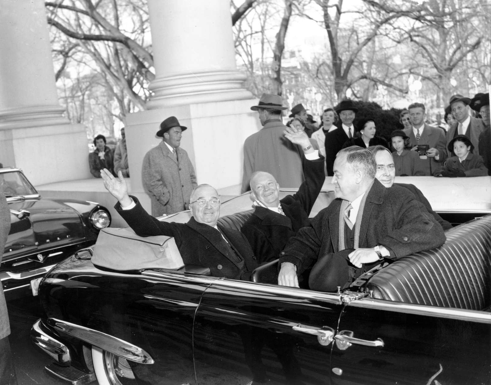 With smiles and a wave, U.S. President Harry Truman, left, and his successor, president-elect Dwight D. Eisenhower, leave the White House in an open car for inauguration ceremonies in Washington, D.C. on Jan. 20, 1953.  Sitting in the front is Sen. Styles Bridges of New Hampshire, and behind him is House Speaker Joe Martin.  (AP Photo)