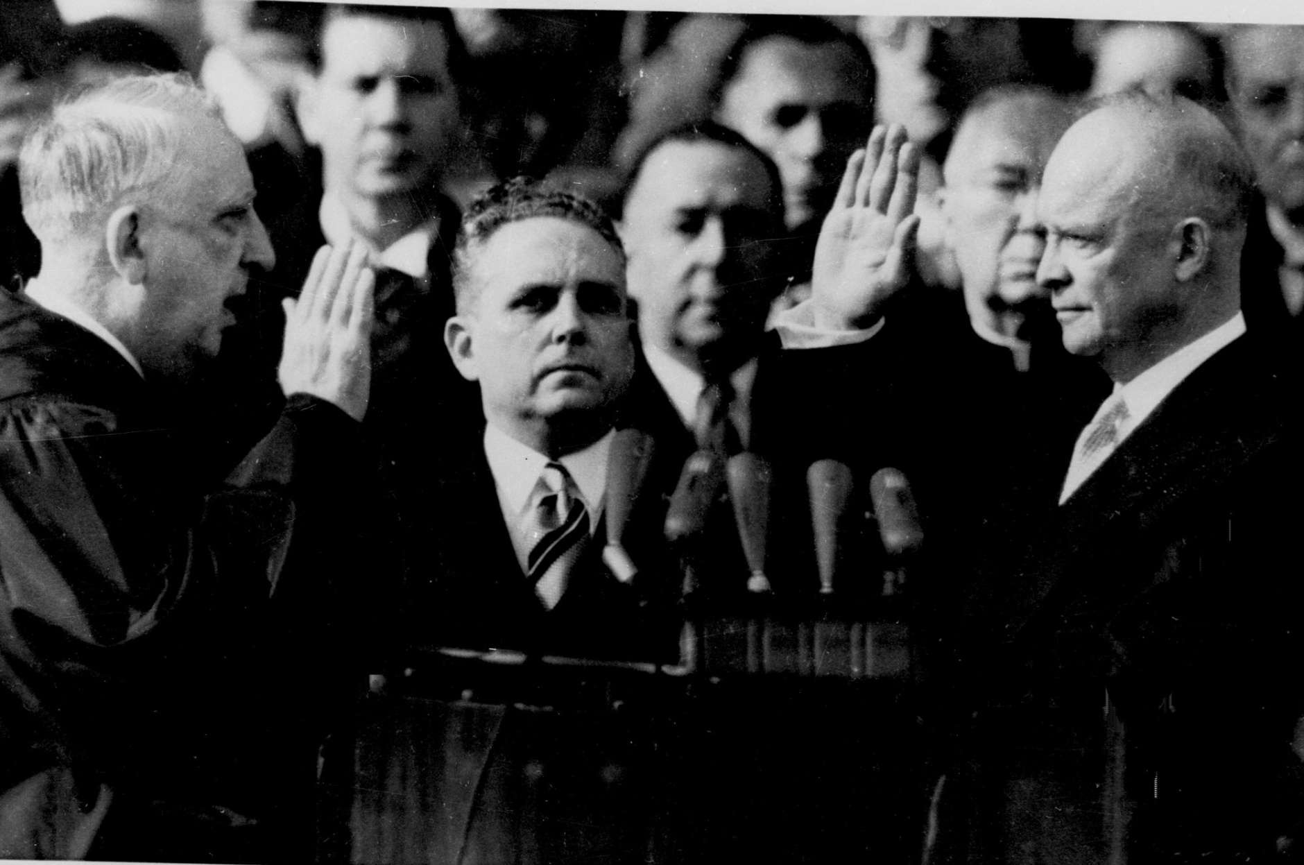 Dwight Eisenhower takes the oath of office January 20, 1953 as president of the United States. The oath is administered by Chief Justice Fred Vinson, left. Supreme Court Clerk Harold B. Willey is at center. (AP Photo)