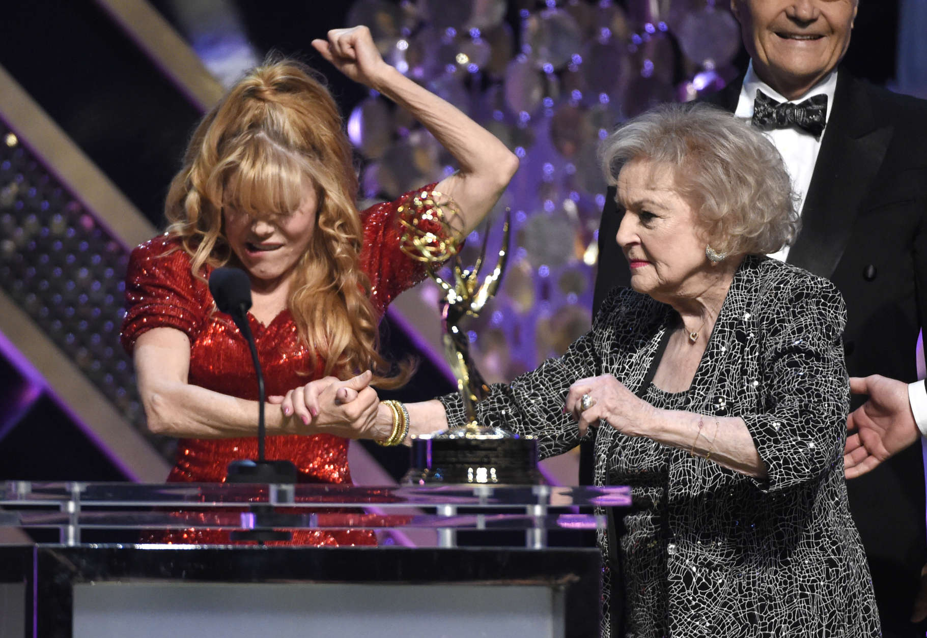 Charo, left, presents Betty White with the lifetime achievement award at the 42nd annual Daytime Emmy Awards at Warner Bros. Studios on Sunday, April 26, 2015, in Burbank, Calif. (Photo by Chris Pizzello/Invision/AP)