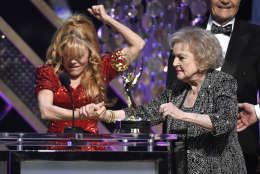 Charo, left, presents Betty White with the lifetime achievement award at the 42nd annual Daytime Emmy Awards at Warner Bros. Studios on Sunday, April 26, 2015, in Burbank, Calif. (Photo by Chris Pizzello/Invision/AP)
