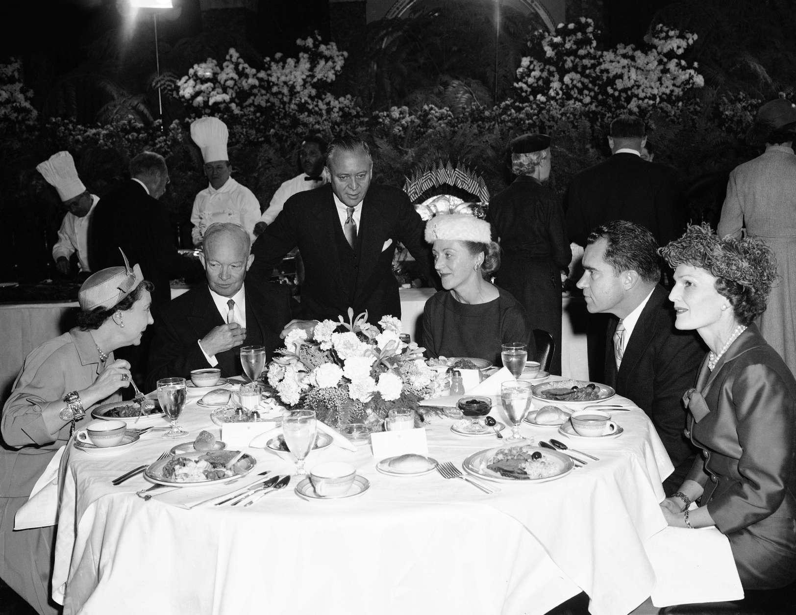President Dwight Eisenhower and wife Mamie Eisenhower have lunch at the capitol in Washington  Jan. 21, 1957, following public inaugural ceremony. From left to right are the Eisenhower, Sen. and Mrs. Styles Bridges of New Hampshire and Vice President Mrs. Nixon. (AP Photo)