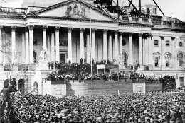 U.S. President Abraham Lincoln stands under cover at center of Capitol steps during his inauguration in Washington, D.C., on March 4, 1861.  The scaffolding at upper right is used in construction of the Capitol dome.  (AP Photo)