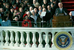 U.S. President Lyndon B. Johnson delivers his inaugural address during inauguration ceremonies on the east portico of the Capitol building in Washington, D.C., Jan. 20, 1965.  Johnson was sworn in as the 36th president of the United States.  Visible in front row, left, is first lady Lady Bird Johnson, who held the bible as her husband took the oath of office, beginning a new tradition.  (AP Photo)