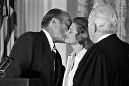 President Gerald R. Ford kisses his wife Betty, Aug. 9, 1974, after he was sworn in as 38th President of the United States by Chief Justice Warren Burger, right, in the East Room of the White House.  (AP Photo)