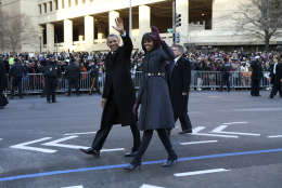 President Barack Obama and first lady Michelle Obama wave as they walk down Pennsylvania Avenue in Washington, Monday, Jan. 21, 2013, during the inaugural parade route , after his ceremonial swearing-in on Capitol Hill during the 57th Presidential Inauguration. (AP Photo/New York Times, Doug Mills, Pool)