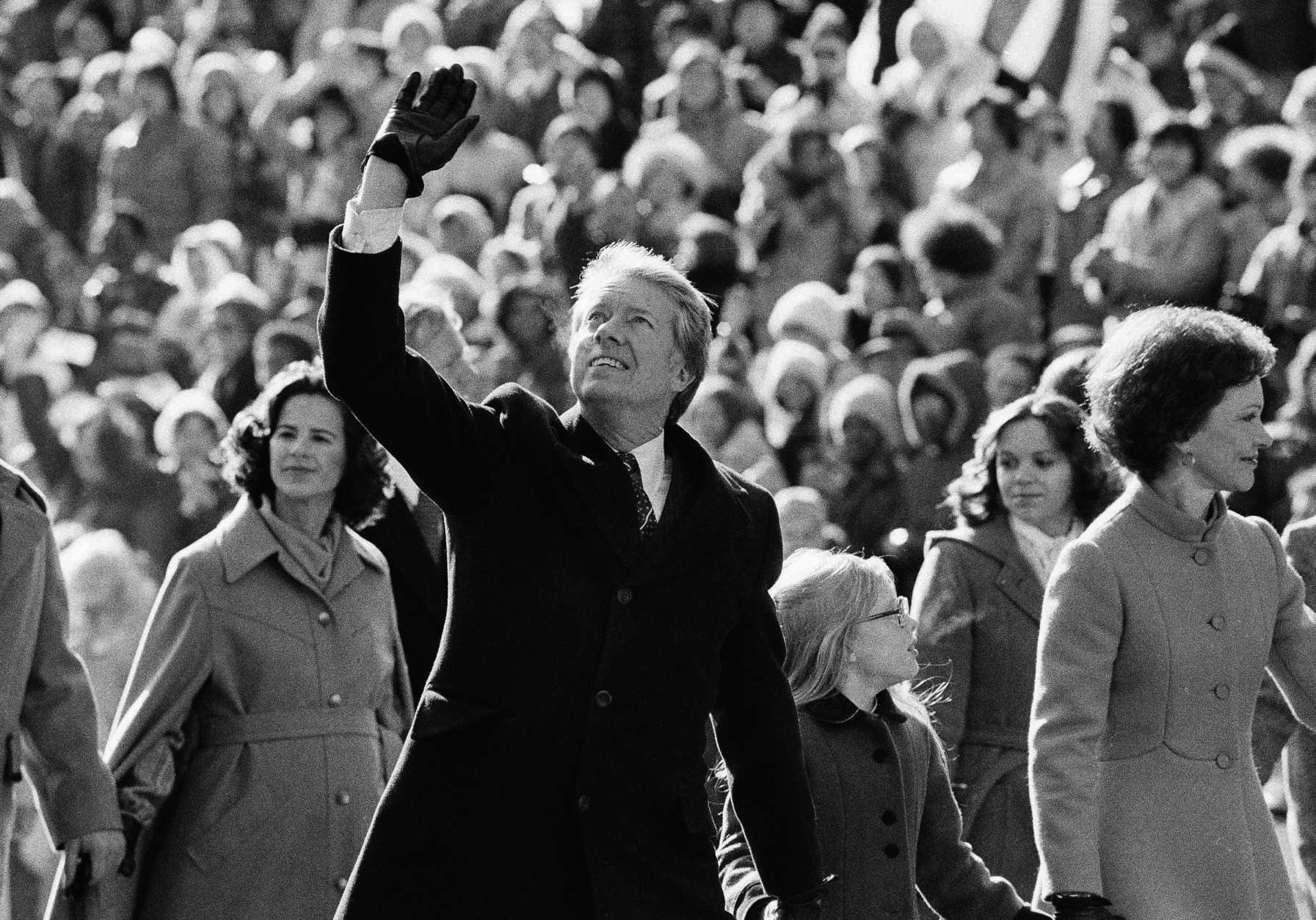 President Jimmy Carter waves to the crowd while walking with his wife Rosalynn along Pennsylvania Avenue and their daughter Amy.  The Carters elected to walk the parade route from the Capitol to the White House following his inauguration in Washington, on Thursday, Jan. 20, 1977. (AP Photo/Suzanne Vlamis)