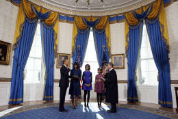 President Barack Obama is officially sworn-in by Chief Justice John Roberts in the Blue Room of the White House during the 57th Presidential Inauguration in Washington, Sunday, Jan. 20, 2013. Next to Obama are first lady Michelle Obama, holding the Robinson Family Bible, and daughters Malia and Sasha. (AP Photo/Larry Downing, Pool)