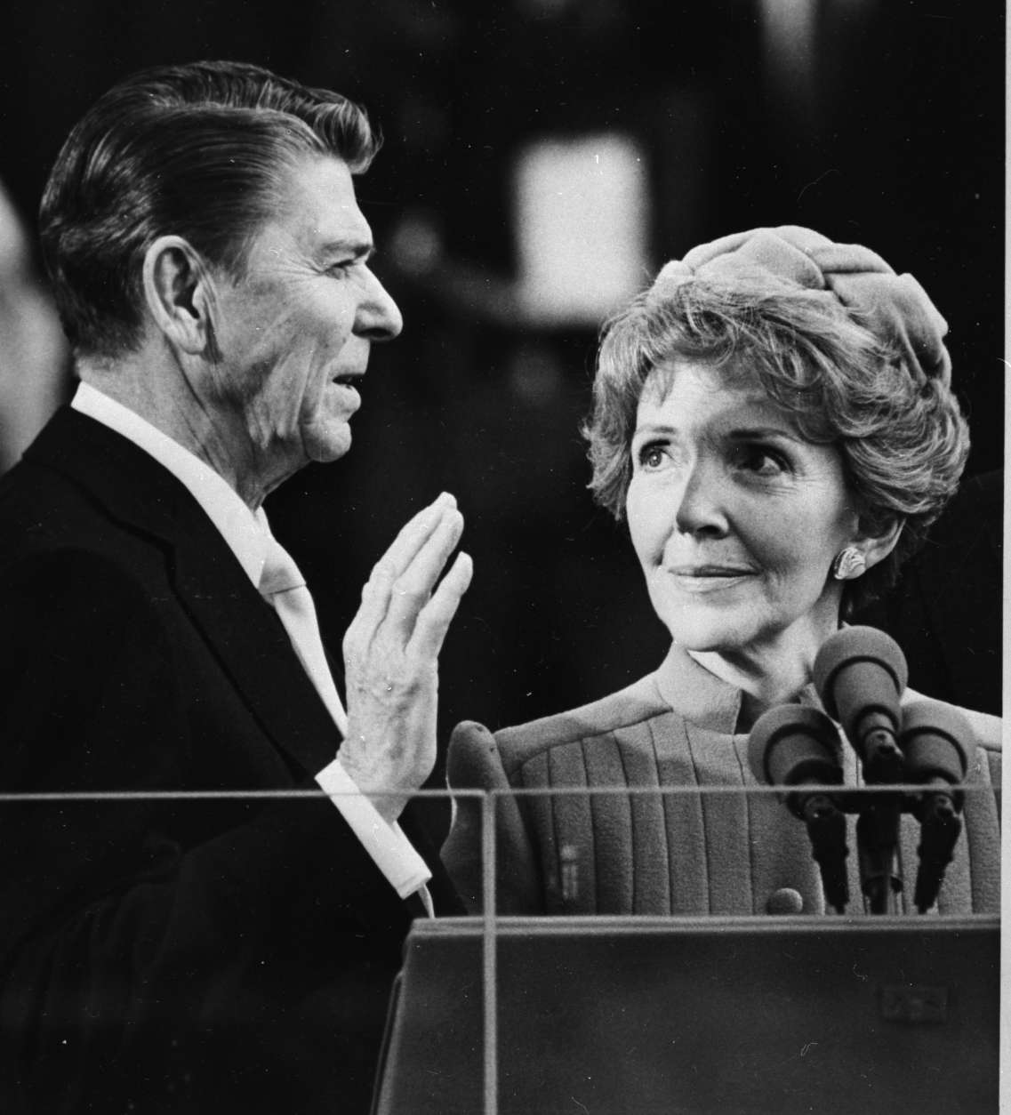 Nancy Reagan proudly watches as her husband Ronald Reagan takes the oath of office at the Capitol January 20, 1981.  (AP Photo)