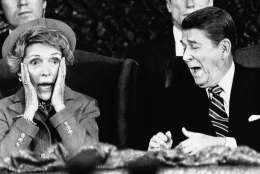 President  Ronald Reagan and wife Nancy  react after Mrs. Reagan sat down after speaking and forgot to introduce the President at the Capital Center in Landover, Md., Monday, Jan. 21, 1985, during an event held for those who would have participated in the inaugural parade, which was canceled because of bad weather. (AP Photo/Scott Stewart)