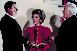 President Ronald Reagan takes the oath of office administered by Chief Justice Warren Burger in a private White House ceremony for a second term in Washington, D.C., Sunday, Jan. 20, 1985.  First Lady Nancy Reagan holds the bible.  (AP Photo/Ira Schwarz)