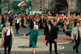 President George Bush, right, and his wife, first lady Barbara Bush, acknowledge the crowd on Pennsylvania Avenue after getting out of their limousine and walking the inaugural parade route in Washington, D.C., Friday, Jan. 20, 1989.  Earlier, Bush was sworn in as the 41st president of the United States.  (AP Photo/Dennis Cook)