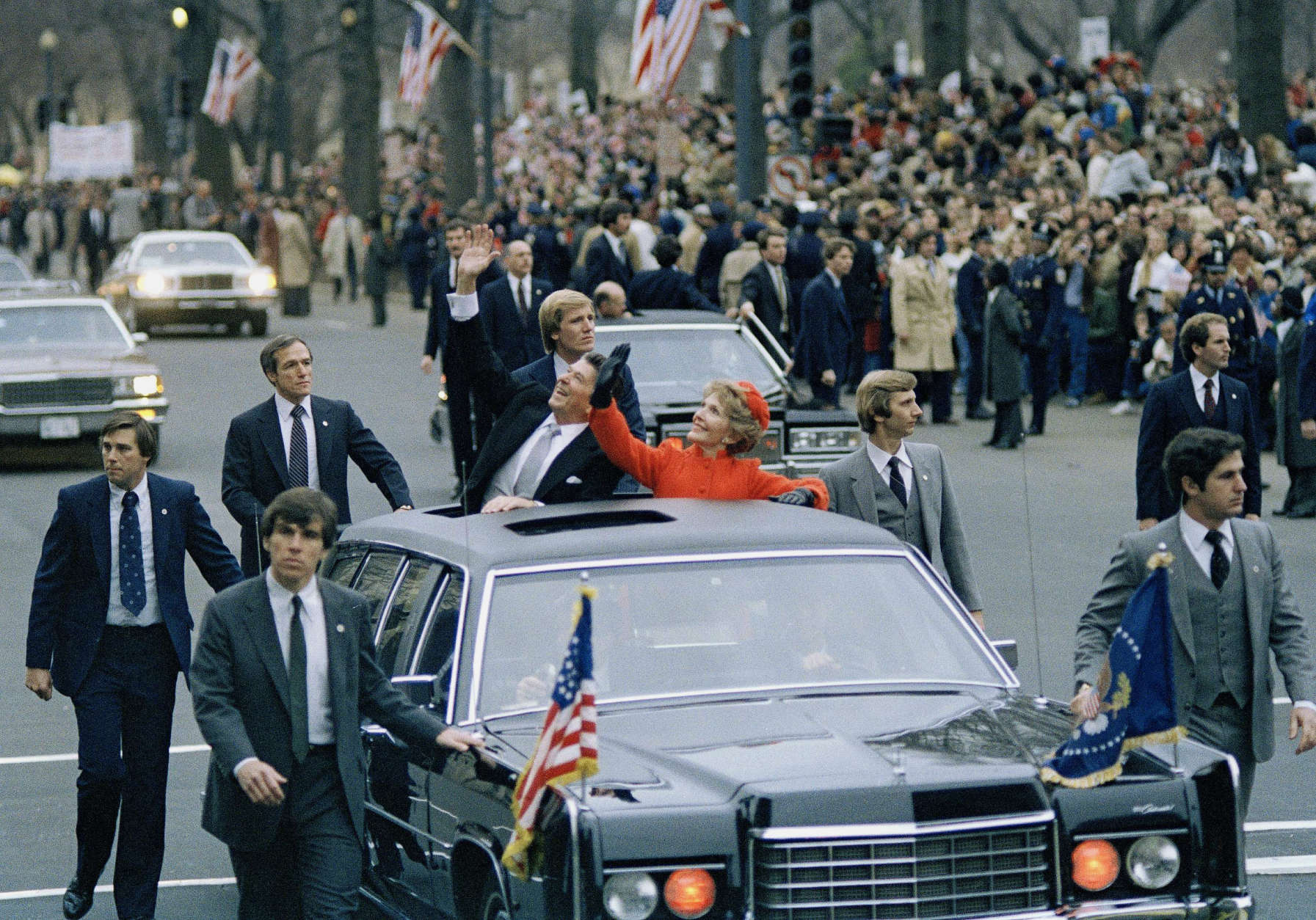 President Ronald Reagan and first lady Nancy Reagan wave from their limousine during the inaugural parade in Washington, D.C., Jan. 20, 1981. (AP Photo)